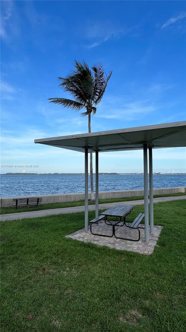 exterior space featuring a yard and a water view