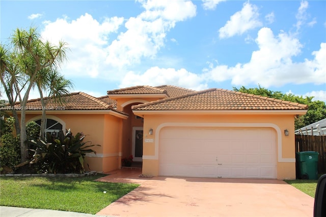 mediterranean / spanish home with a garage, concrete driveway, a tile roof, a front lawn, and stucco siding