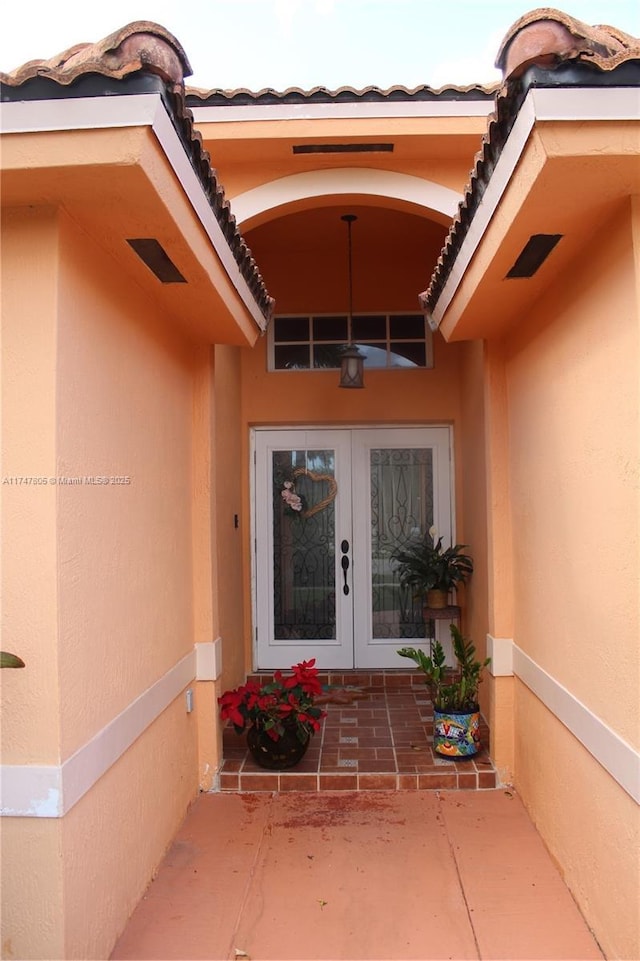 entrance to property with french doors and a patio area