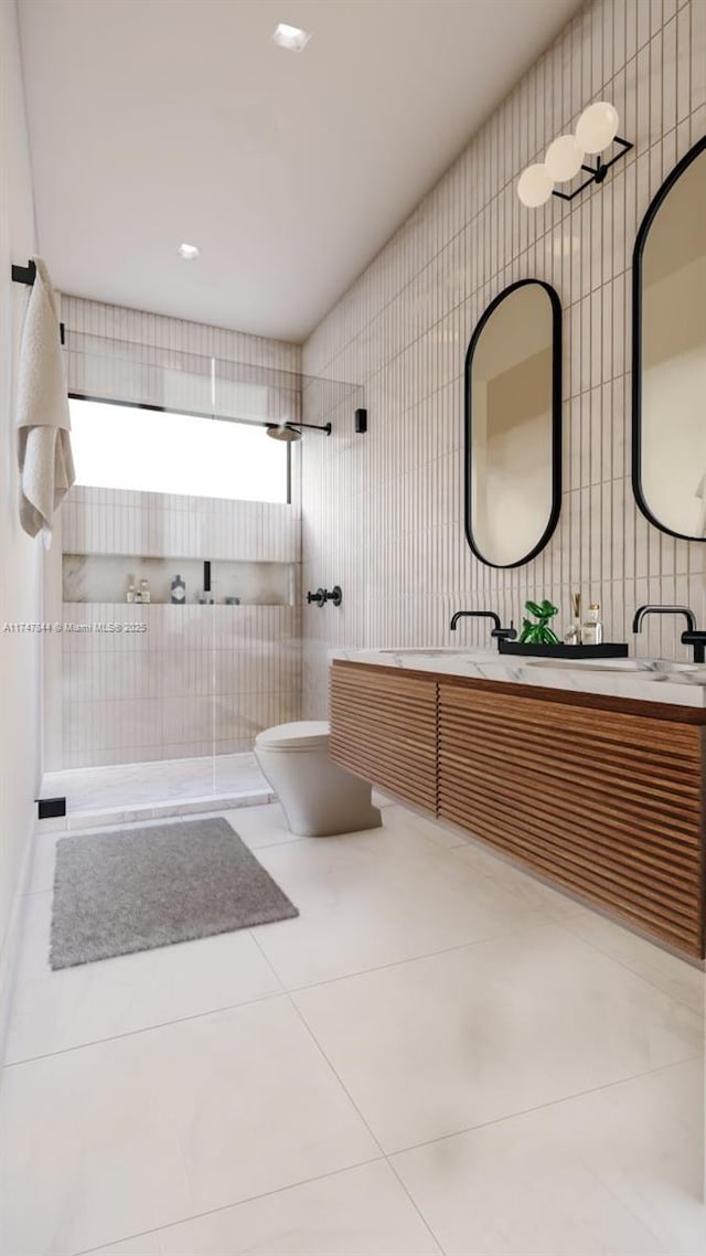 bathroom with tile walls, vanity, tile patterned floors, and walk in shower