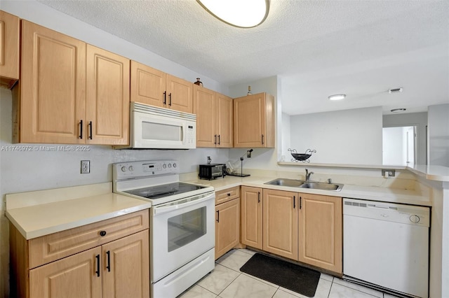 kitchen with light brown cabinetry, white appliances, a textured ceiling, light tile patterned flooring, and sink