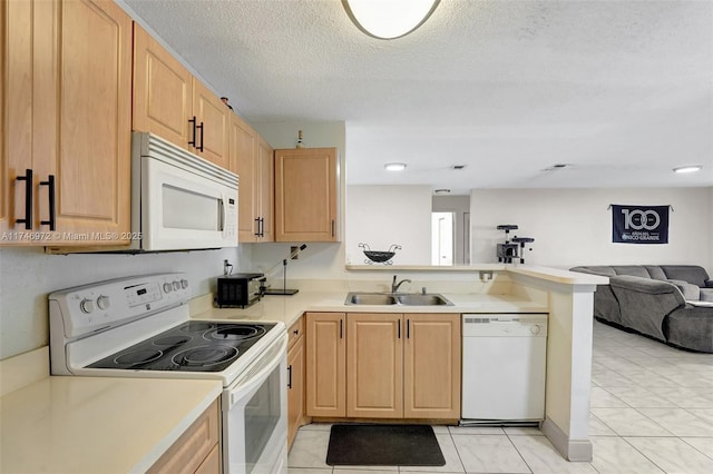 kitchen featuring light brown cabinetry, white appliances, a textured ceiling, sink, and kitchen peninsula