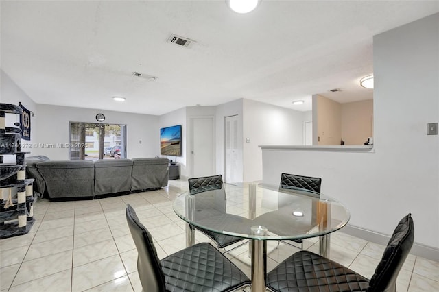 dining space with light tile patterned floors