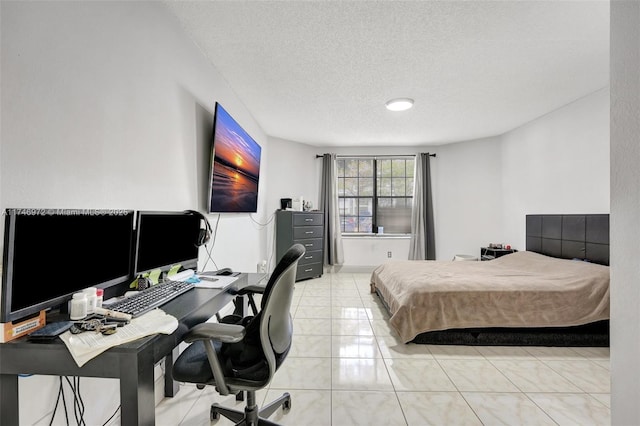 bedroom featuring light tile patterned flooring and a textured ceiling