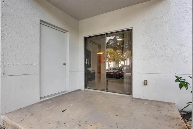 doorway to property featuring a patio area