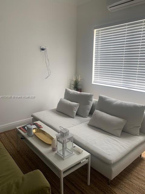 living room featuring a wall mounted air conditioner