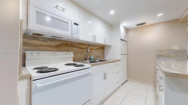 kitchen with white cabinetry, sink, backsplash, white appliances, and light tile patterned flooring