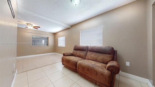 tiled living room featuring ceiling fan and a textured ceiling