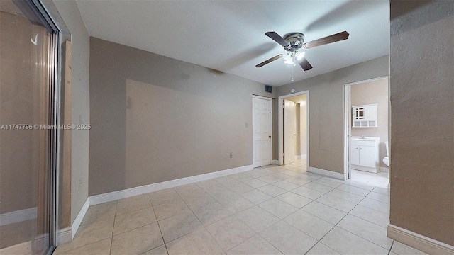 unfurnished room with light tile patterned flooring and ceiling fan