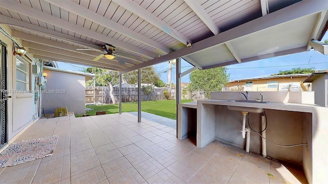 view of patio / terrace with ceiling fan and sink