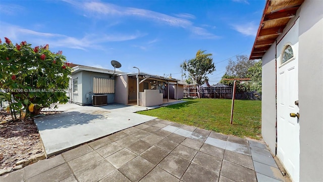 exterior space with central AC, a patio area, and a lawn