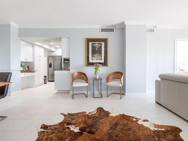 living area featuring ornamental molding, light tile patterned flooring, visible vents, and baseboards