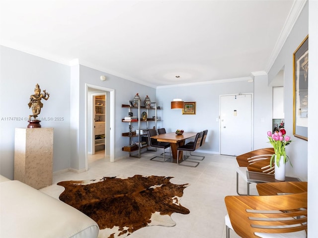 dining area with baseboards and crown molding