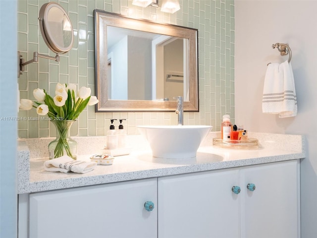 bathroom with tasteful backsplash and vanity