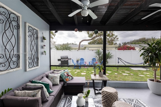 sunroom / solarium featuring ceiling fan