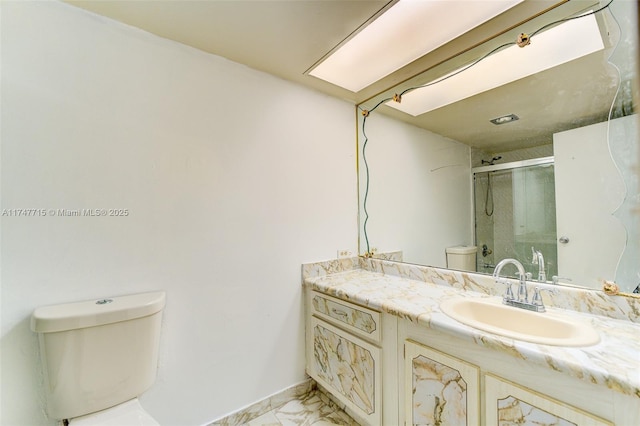 bathroom with vanity, toilet, and walk in shower