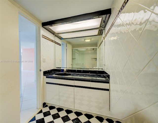 bathroom with tile walls and vanity