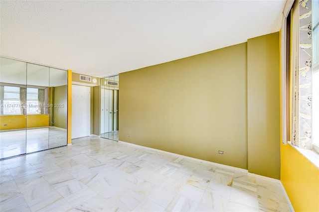 unfurnished bedroom with a textured ceiling