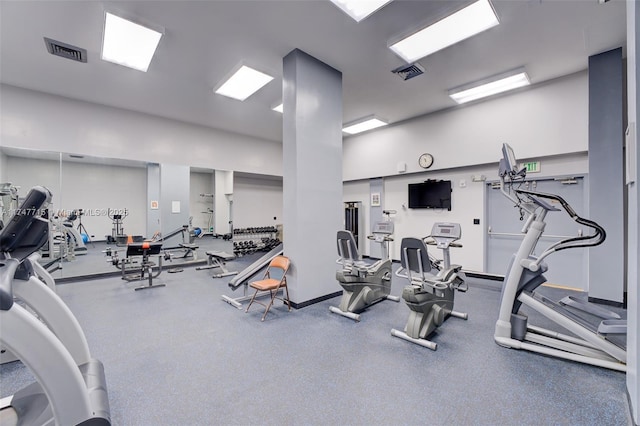 workout area with a high ceiling