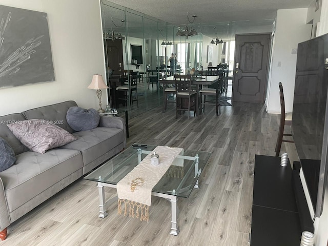 living room with a textured ceiling and wood-type flooring