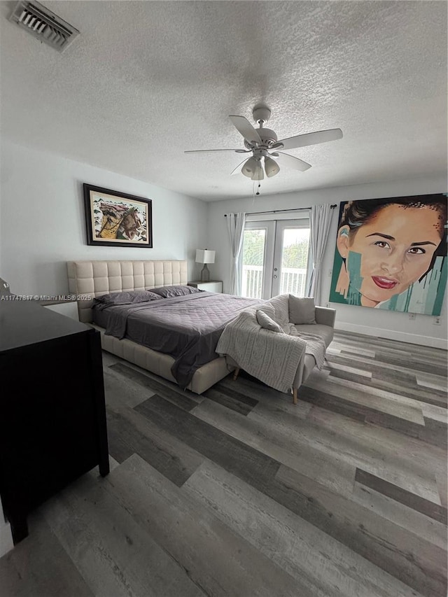 bedroom with ceiling fan, wood-type flooring, french doors, and access to exterior