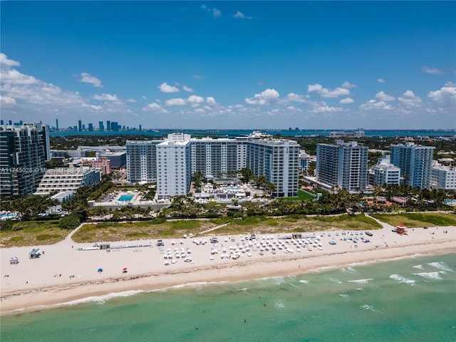 drone / aerial view with a water view and a beach view