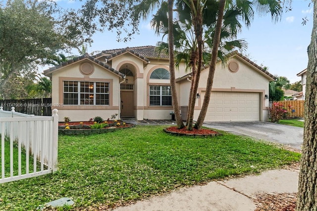 mediterranean / spanish-style home with a front lawn and a garage