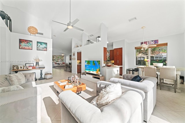 tiled living room featuring high vaulted ceiling and ceiling fan