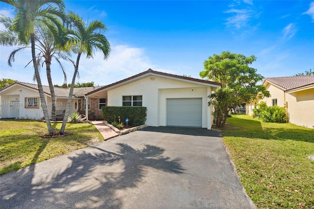 ranch-style house with a garage and a front yard