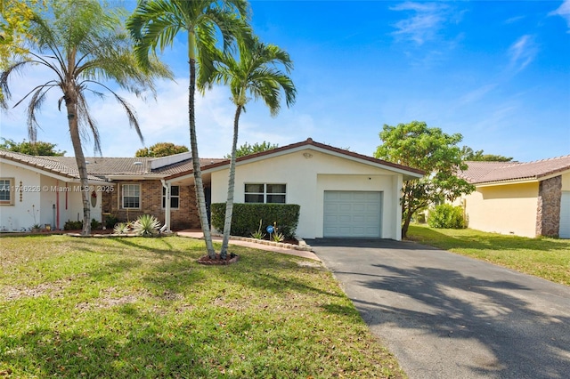 ranch-style home with a front lawn and a garage