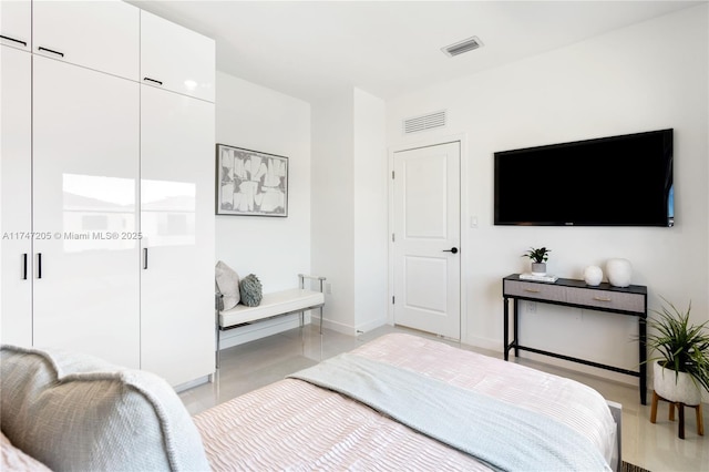 bedroom featuring visible vents and baseboards