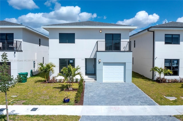 view of front of house with a balcony, stucco siding, decorative driveway, and a front lawn