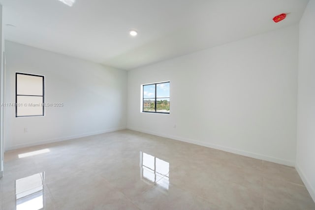 spare room featuring light tile patterned floors, baseboards, and recessed lighting