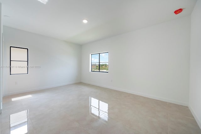 unfurnished room featuring light tile patterned flooring, recessed lighting, and baseboards