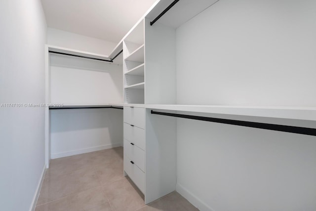 spacious closet with light tile patterned floors