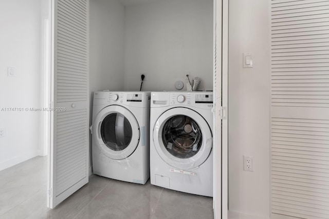 clothes washing area featuring washer and dryer and laundry area