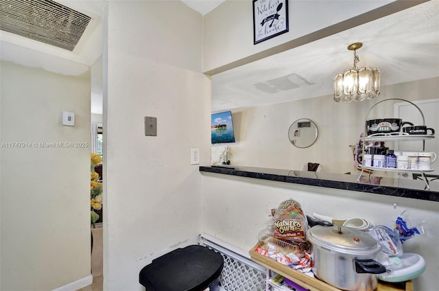 kitchen with hanging light fixtures and a chandelier