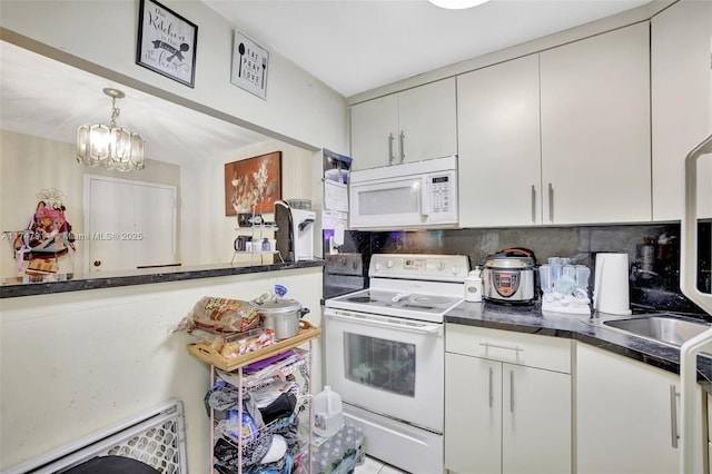 kitchen with white appliances, white cabinetry, pendant lighting, and backsplash