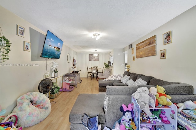 living room featuring a textured ceiling and hardwood / wood-style floors