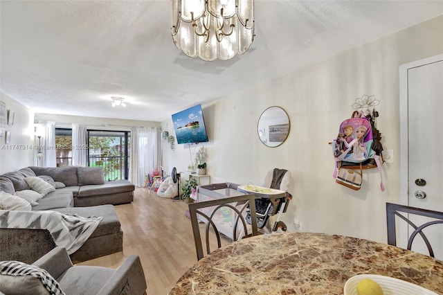 living room with light wood-type flooring and a textured ceiling