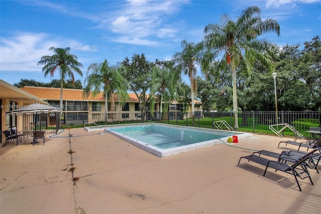 view of swimming pool with a patio area and a jacuzzi