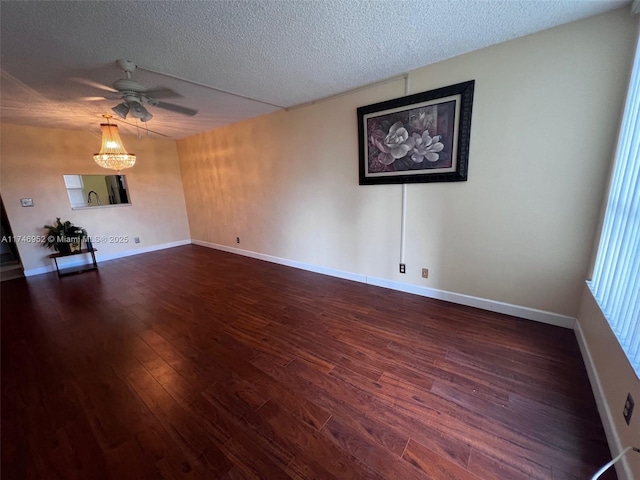 unfurnished room featuring a textured ceiling, dark wood-type flooring, and ceiling fan