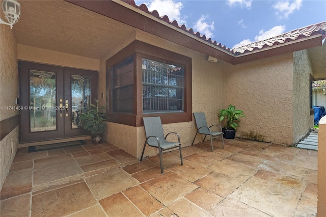 653 NW 110th Ave, Coral Springs, FL 33071 - view of exterior entry featuring french doors and a patio