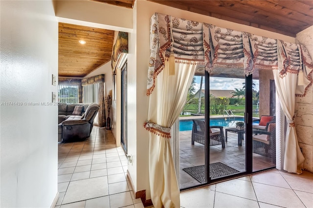 653 NW 110th Ave, Coral Springs, FL 33071 - doorway to outside featuring light tile patterned floors, wood ceiling, and vaulted ceiling