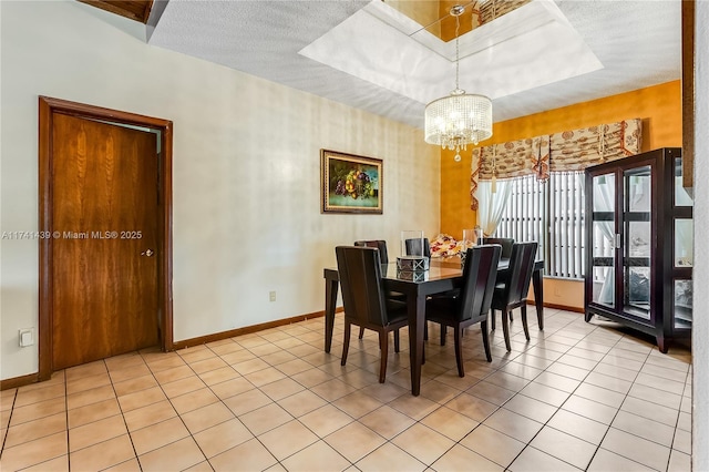 653 NW 110th Ave, Coral Springs, FL 33071 - tiled dining room with a tray ceiling, a textured ceiling, and a chandelier