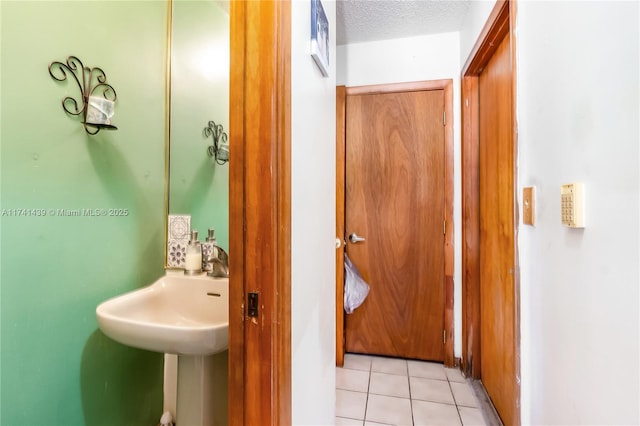653 NW 110th Ave, Coral Springs, FL 33071 - bathroom with a textured ceiling and tile patterned floors