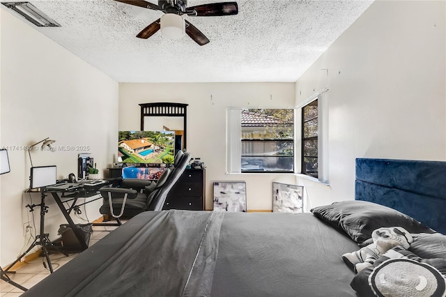 653 NW 110th Ave, Coral Springs, FL 33071 - bedroom with ceiling fan, light tile patterned floors, and a textured ceiling
