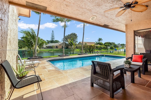 653 NW 110th Ave, Coral Springs, FL 33071 - view of swimming pool featuring ceiling fan, a water view, and a patio