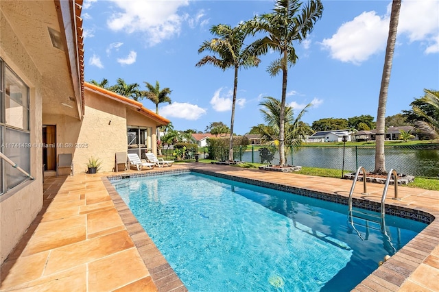 653 NW 110th Ave, Coral Springs, FL 33071 - view of swimming pool featuring a patio area and a water view