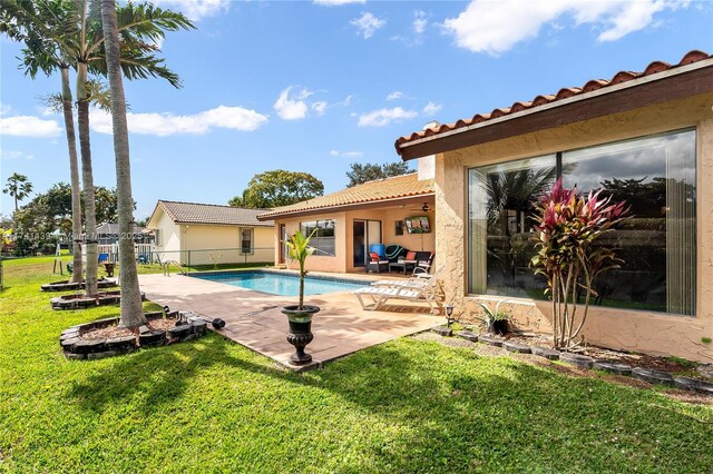 653 NW 110th Ave, Coral Springs, FL 33071 - view of swimming pool with a yard and a patio